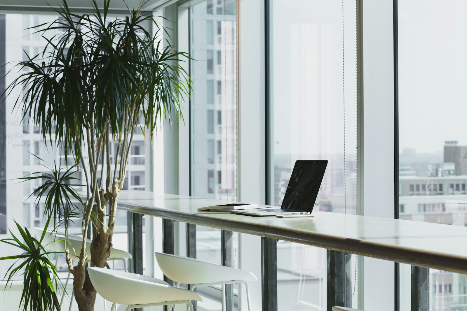 A quiet workspace with notebooks and a laptop